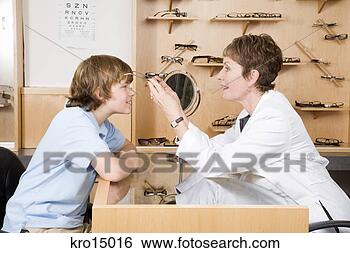 Stock Photo - female optician 
putting eyeglasses 
on boy. fotosearch 
- search stock 
photos, pictures, 
images, and photo 
clipart