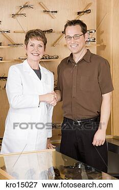 Picture - female optician 
shaking hands 
with man. fotosearch 
- search stock 
photos, pictures, 
images, and photo 
clipart