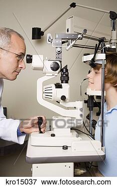 Picture - male ophthalmologist 
examining boy. 
fotosearch - search 
stock photos, 
pictures, images, 
and photo clipart