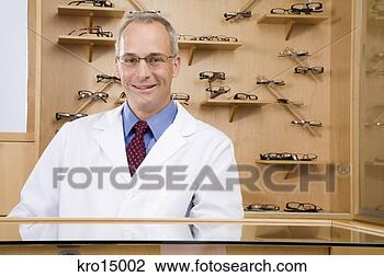 Stock Photo - male optician 
behind counter. 
fotosearch - search 
stock photos, 
pictures, images, 
and photo clipart