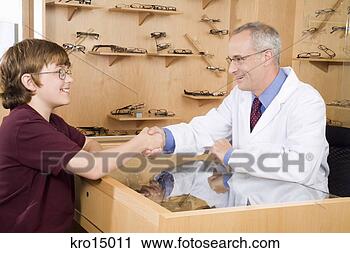 Stock Photography - male optician 
shaking hands 
with boy. fotosearch 
- search stock 
photos, pictures, 
images, and photo 
clipart