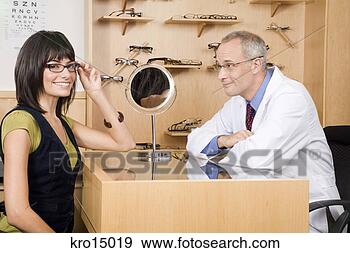 Stock Photograph - male optician 
with woman in 
office. fotosearch 
- search stock 
photos, pictures, 
images, and photo 
clipart