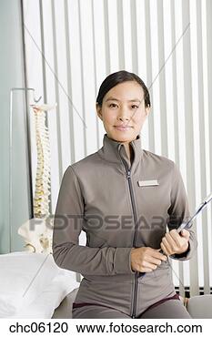 Stock Photography - asian female physical 
therapist holding 
chart. fotosearch 
- search stock 
photos, pictures, 
images, and photo 
clipart