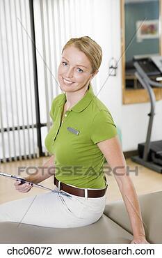 Stock Photo - female physical 
therapist holding 
chart. fotosearch 
- search stock 
photos, pictures, 
images, and photo 
clipart