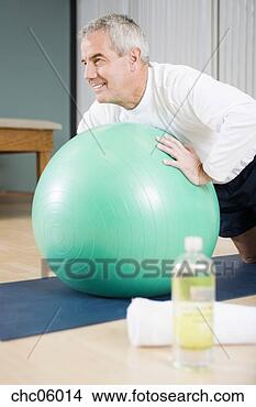 Stock Photo - senior man exercising 
on ball. fotosearch 
- search stock 
photos, pictures, 
images, and photo 
clipart