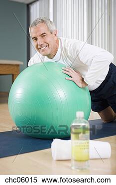 Stock Image - senior man exercising 
on ball. fotosearch 
- search stock 
photos, pictures, 
images, and photo 
clipart