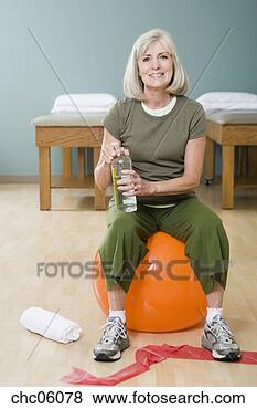 Stock Photo - woman sitting 
on exercise ball. 
fotosearch - search 
stock photos, 
pictures, images, 
and photo clipart