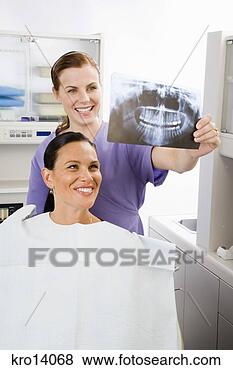 Stock Photo - female dentist 
examining woman’s 
x-ray. fotosearch 
- search stock 
photos, pictures, 
images, and photo 
clipart