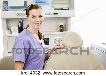 Stock Photo - female dentist 
next to dental 
chair. fotosearch 
- search stock 
photos, pictures, 
images, and photo 
clipart
