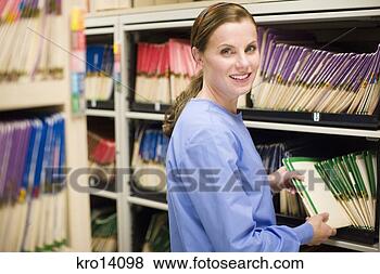Stock Photo - female doctor 
taking file off 
shelf. fotosearch 
- search stock 
photos, pictures, 
images, and photo 
clipart