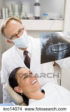 Stock Photo - male dentist examining 
woman’s x-ray. 
fotosearch - search 
stock photos, 
pictures, images, 
and photo clipart