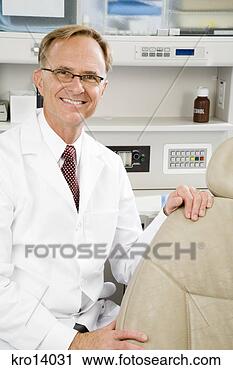 Stock Photography - male dentist next 
to dental chair. 
fotosearch - search 
stock photos, 
pictures, images, 
and photo clipart