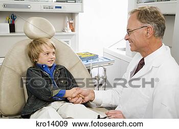 Stock Photograph - male dentist shaking 
boy’s hand. fotosearch 
- search stock 
photos, pictures, 
images, and photo 
clipart