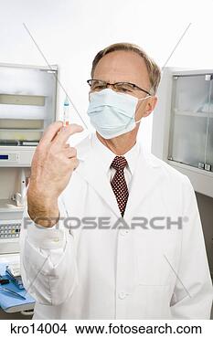 Stock Photo - male doctor holding 
syringe. fotosearch 
- search stock 
photos, pictures, 
images, and photo 
clipart