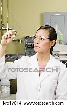 Stock Photo - asian female scientist 
examining vial. 
fotosearch - search 
stock photos, 
pictures, images, 
and photo clipart