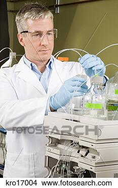 Stock Photo - male scientist 
attaching hoses 
to bottles. fotosearch 
- search stock 
photos, pictures, 
images, and photo 
clipart