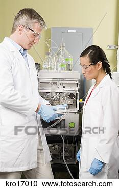 Stock Photography - multi-ethnic scientists 
looking at equipment. 
fotosearch - search 
stock photos, 
pictures, images, 
and photo clipart