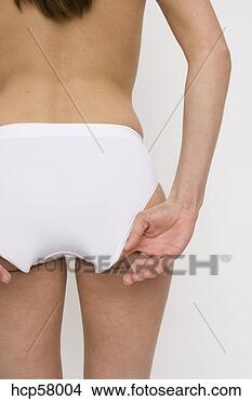 Stock Photo - woman adjusting 
her underwear. 
fotosearch - search 
stock photos, 
pictures, images, 
and photo clipart
