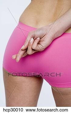 Stock Photography - young woman crossing 
her fingers behind 
her back. fotosearch 
- search stock 
photos, pictures, 
images, and photo 
clipart