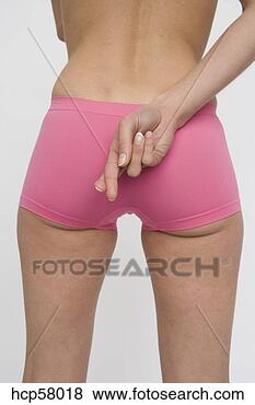Stock Photo - young woman crossing 
her fingers behind 
her back. fotosearch 
- search stock 
photos, pictures, 
images, and photo 
clipart