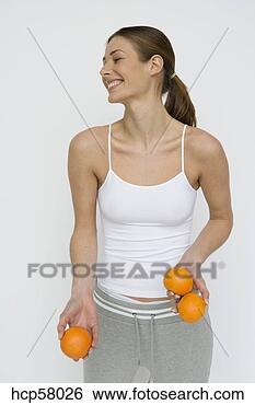 Stock Photo - young woman holding 
oranges. fotosearch 
- search stock 
photos, pictures, 
images, and photo 
clipart