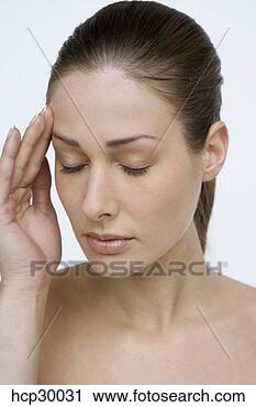 Stock Photography - young woman rubbing 
forehead. fotosearch 
- search stock 
photos, pictures, 
images, and photo 
clipart