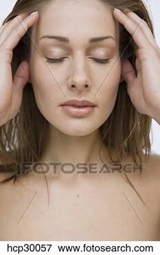 Picture - young woman rubbing 
her forehead. 
fotosearch - search 
stock photos, 
pictures, images, 
and photo clipart