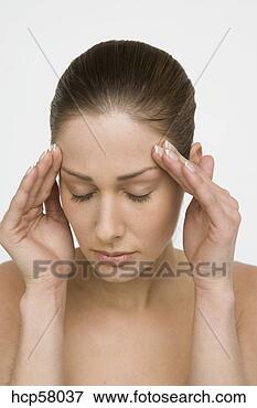Picture - young woman rubbing 
her forehead. 
fotosearch - search 
stock photos, 
pictures, images, 
and photo clipart