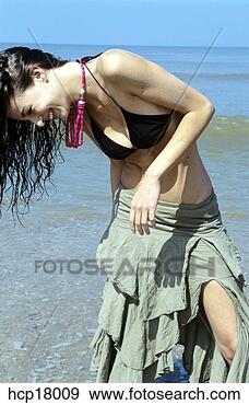 Stock Photograph - young woman laughing 
at beach. fotosearch 
- search stock 
photos, pictures, 
images, and photo 
clipart
