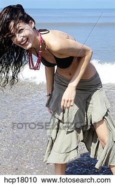Stock Photography - young woman laughing 
at beach. fotosearch 
- search stock 
photos, pictures, 
images, and photo 
clipart
