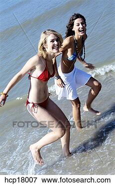 Picture - young women running 
and laughing at 
beach. fotosearch 
- search stock 
photos, pictures, 
images, and photo 
clipart