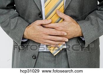 Stock Photograph - businessman holding 
his stomach. fotosearch 
- search stock 
photos, pictures, 
images, and photo 
clipart