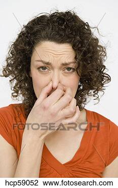 Stock Photo - woman holding 
her nose. fotosearch 
- search stock 
photos, pictures, 
images, and photo 
clipart