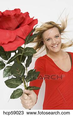 Stock Photo - woman holding 
out oversized 
flower. fotosearch 
- search stock 
photos, pictures, 
images, and photo 
clipart