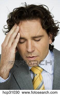 Stock Photography - young businessman 
rubbing his forehead. 
fotosearch - search 
stock photos, 
pictures, images, 
and photo clipart