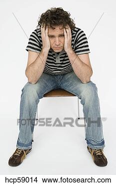 Stock Photo - young man sitting 
in chair. fotosearch 
- search stock 
photos, pictures, 
images, and photo 
clipart