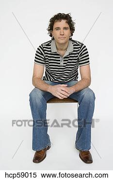Stock Image - young man sitting 
in chair. fotosearch 
- search stock 
photos, pictures, 
images, and photo 
clipart