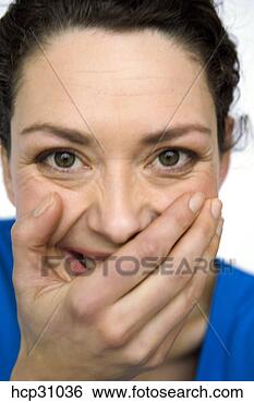 Stock Photo - young woman covering 
her mouth. fotosearch 
- search stock 
photos, pictures, 
images, and photo 
clipart