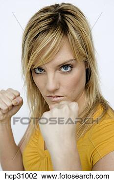 Stock Photo - young woman with 
fists up, readying 
to fight. fotosearch 
- search stock 
photos, pictures, 
images, and photo 
clipart
