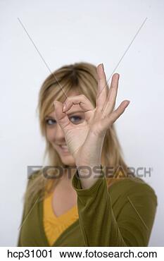 Stock Photography - young woman looking 
through a hole 
in her fingers. 
fotosearch - search 
stock photos, 
pictures, images, 
and photo clipart