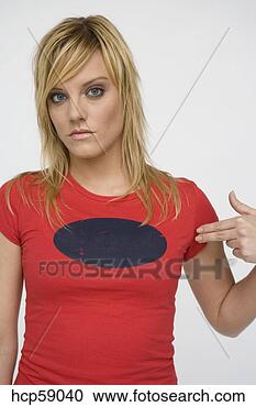 Stock Photography - young woman pointing 
at shirt. fotosearch 
- search stock 
photos, pictures, 
images, and photo 
clipart