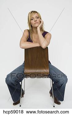 Stock Photo - young woman sitting 
in chair. fotosearch 
- search stock 
photos, pictures, 
images, and photo 
clipart