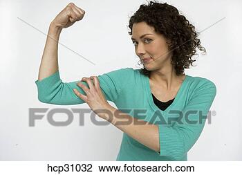 Stock Photo - young woman squeezing 
her muscles. fotosearch 
- search stock 
photos, pictures, 
images, and photo 
clipart