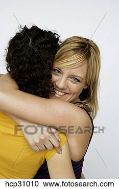 Stock Photography - young women hugging. 
fotosearch - search 
stock photos, 
pictures, images, 
and photo clipart