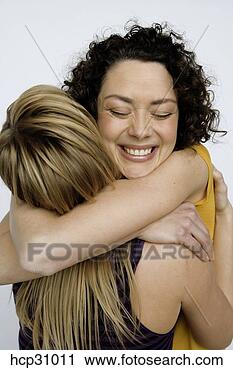 Stock Photography - young women hugging. 
fotosearch - search 
stock photos, 
pictures, images, 
and photo clipart