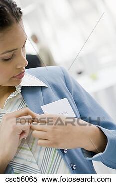 Stock Image - african businesswoman 
putting on name 
tag. fotosearch 
- search stock 
photos, pictures, 
images, and photo 
clipart