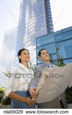 Stock Photograph - businesspeople 
holding blueprints. 
fotosearch - search 
stock photos, 
pictures, images, 
and photo clipart