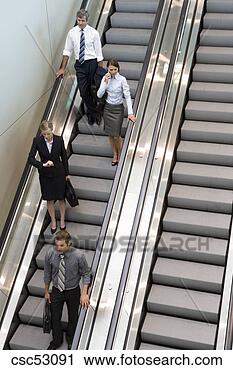 Stock Photography - businesspeople 
standing on escalator. 
fotosearch - search 
stock photos, 
pictures, images, 
and photo clipart