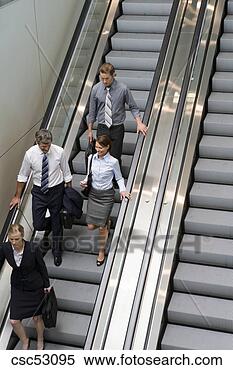 Stock Image - businesspeople 
standing on escalator. 
fotosearch - search 
stock photos, 
pictures, images, 
and photo clipart