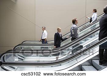 Stock Photo - businesspeople 
standing on escalators. 
fotosearch - search 
stock photos, 
pictures, images, 
and photo clipart